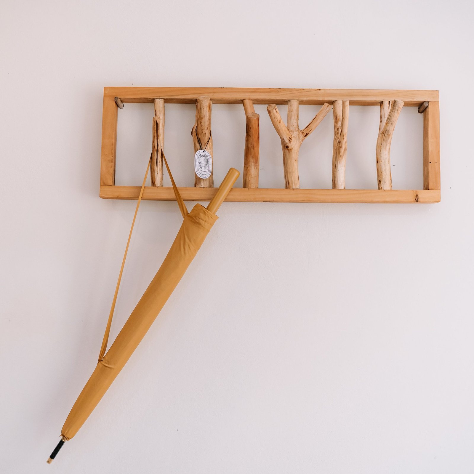 The branch coat rack on the bedroom wall